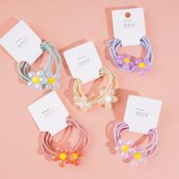 2 élastiques pour cheveux avec des motifs de fleurs colorées.