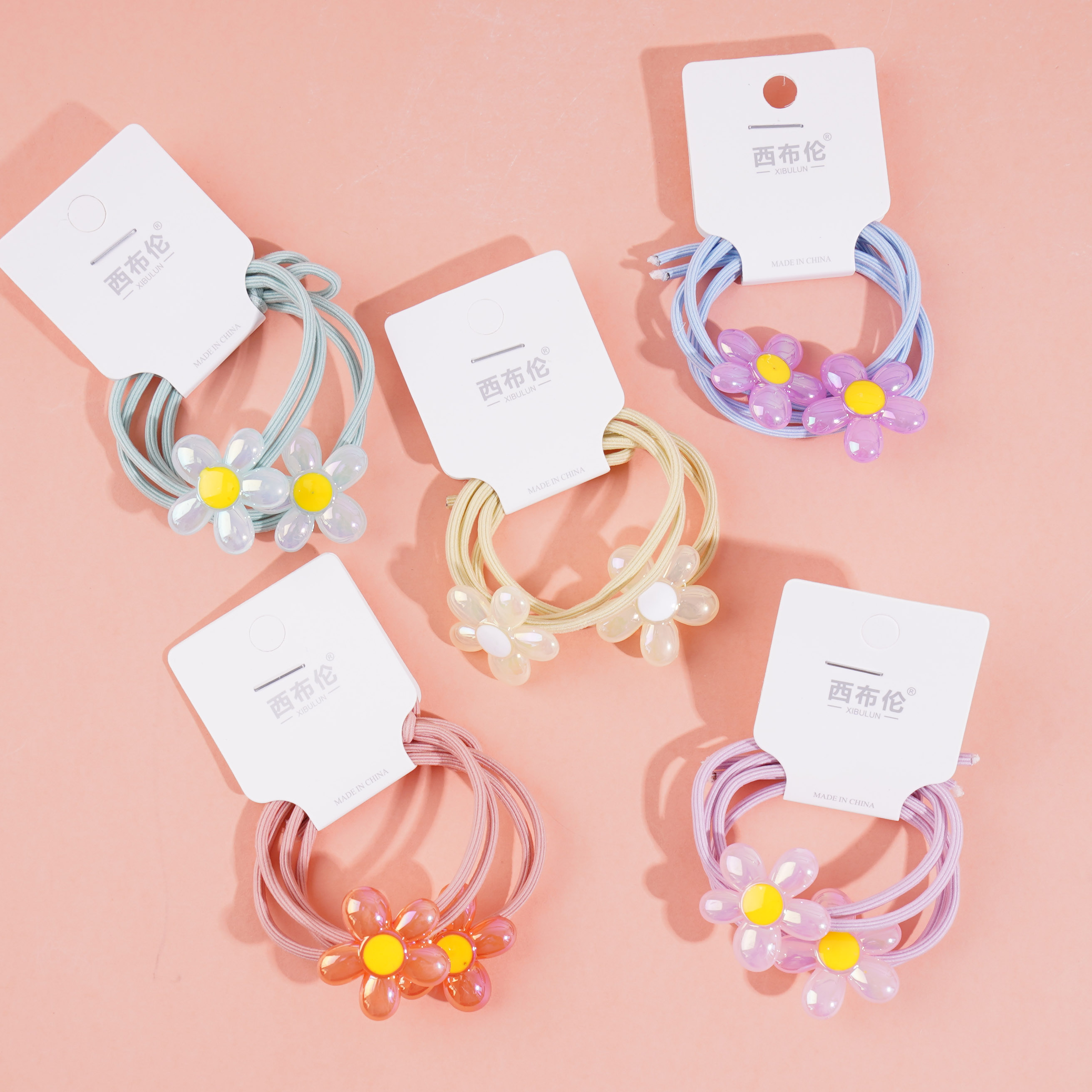 2 colorful flower-themed headbands with elastic bands