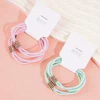 2 colorful square diamond-shaped rubber bands