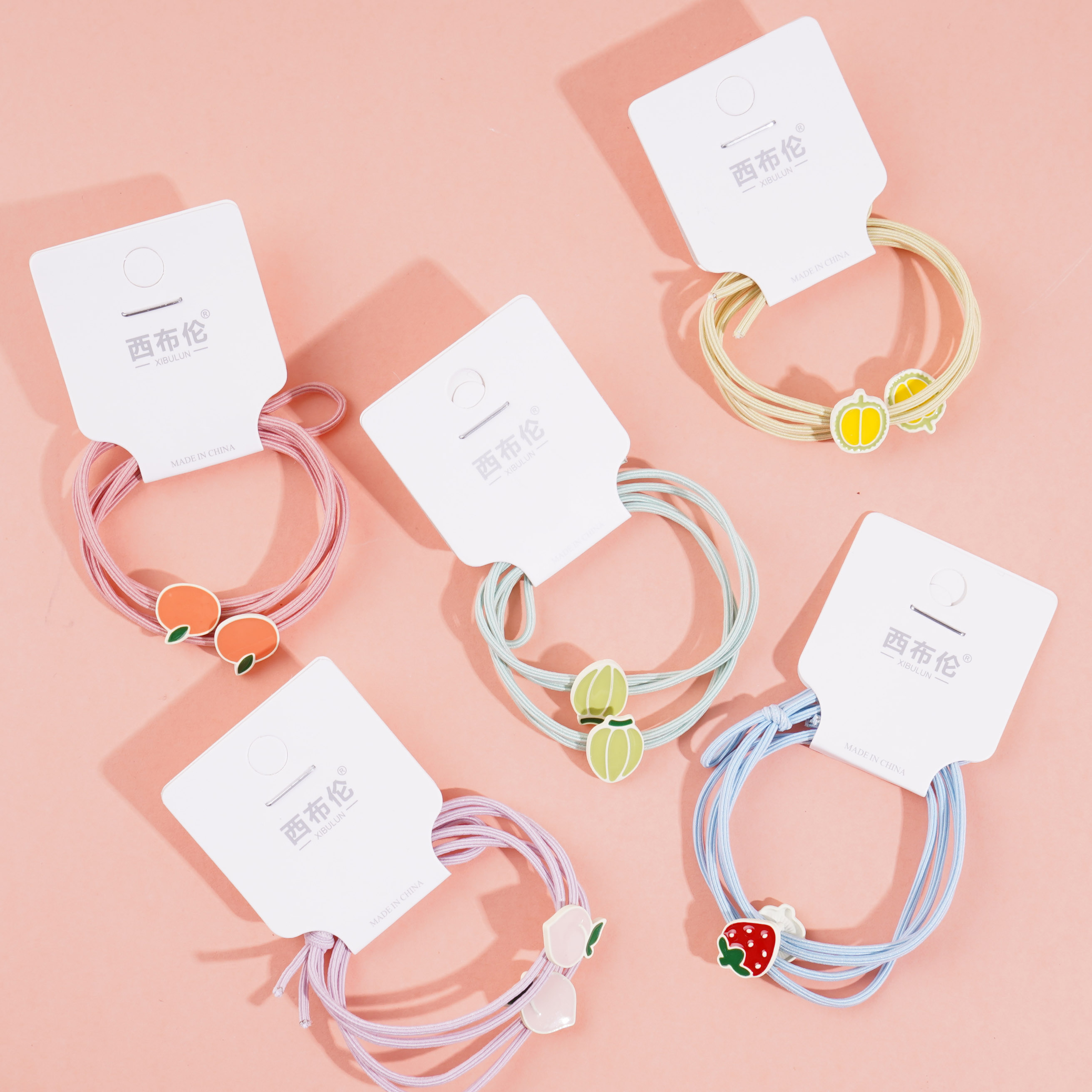 2 colorful fruit-themed rubber bands for hair ties