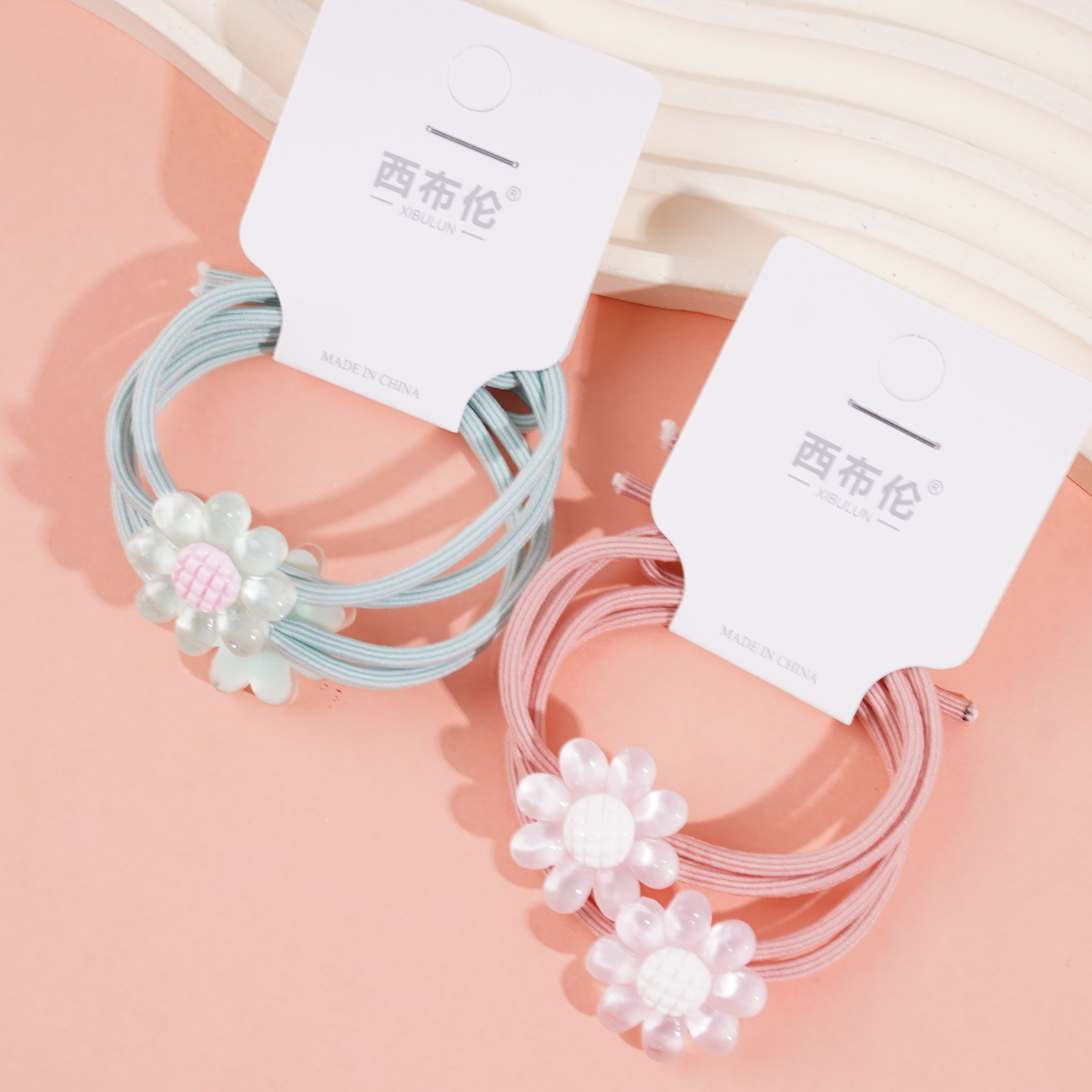 2 colorful small flower-themed rubber bands