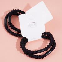 2 black ponytail elastics with a bow-shaped design