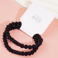 2 black ponytail elastics with a bow-shaped design