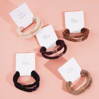 2 brown flat beads with thick head ropes and rubber bands