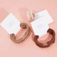 2 brown flat beads with thick head ropes and rubber bands