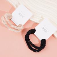 2 brown flat beads with thick head ropes and rubber bands