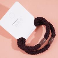 2 brown flat beads with thick head ropes and rubber bands