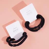 2 black flat beads with thickened heads and rubber bands
