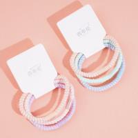 3 colorful dotted headbands and rubber bands