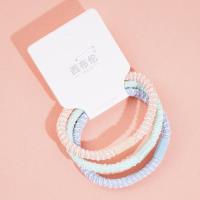 3 colorful dotted headbands and rubber bands