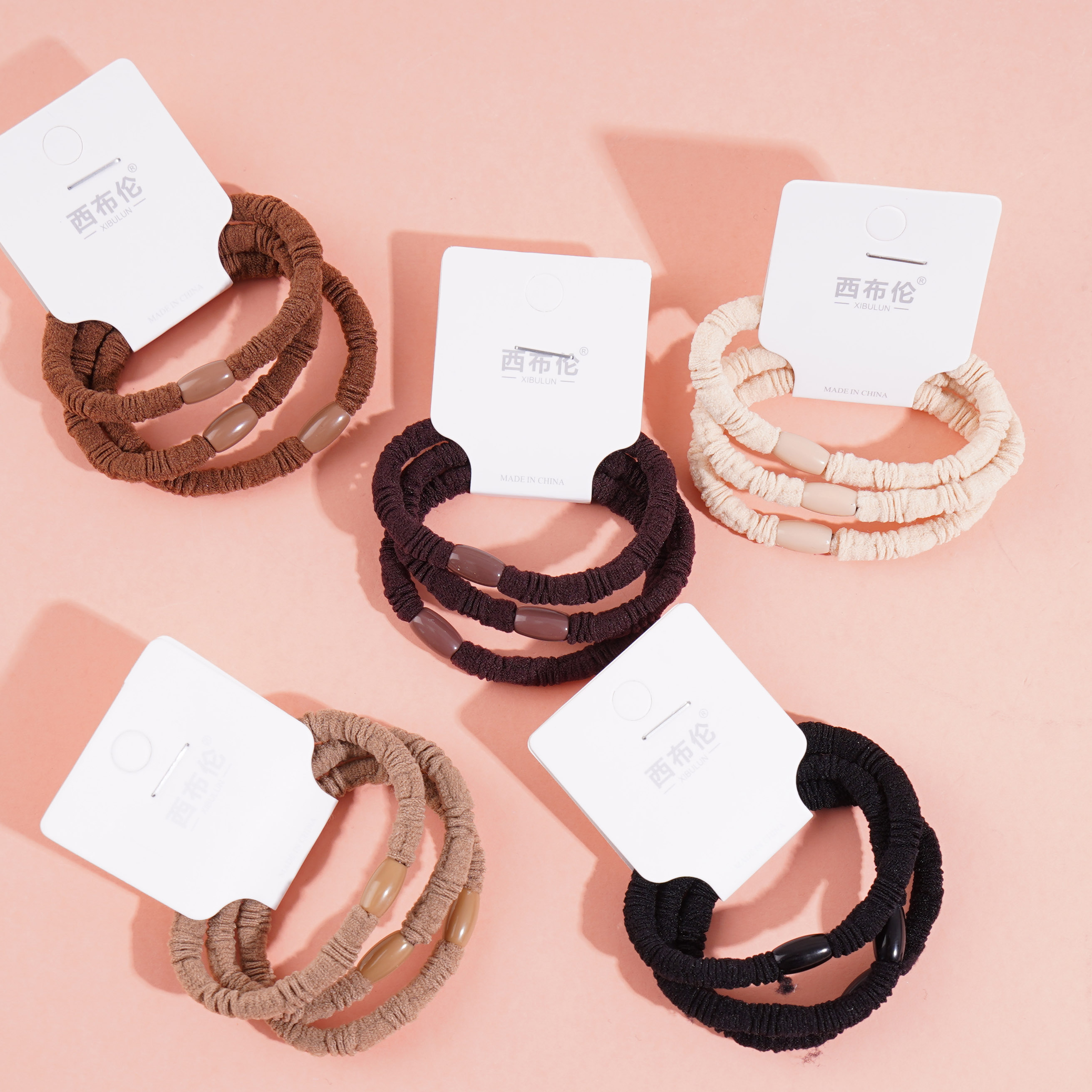 3 brown round bead head rubber bands