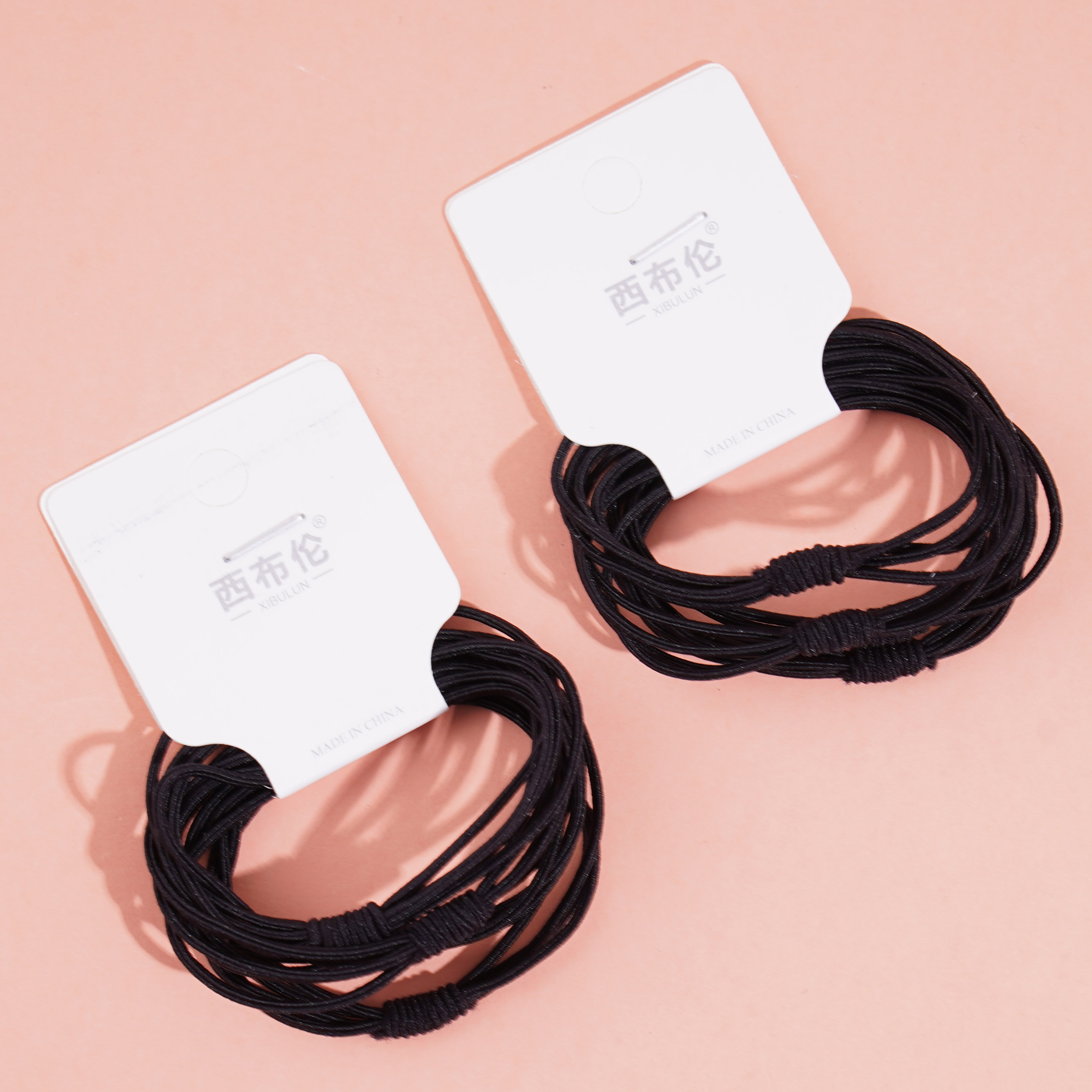 4 pieces of thin rope with knotted ends and rubber bands