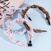 Une pince à cheveux en forme de tête de diamant plissée.