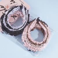 Une pince à cheveux en forme de tête de diamant plissée.