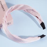 A knotted lace headband with dots and a bow decoration