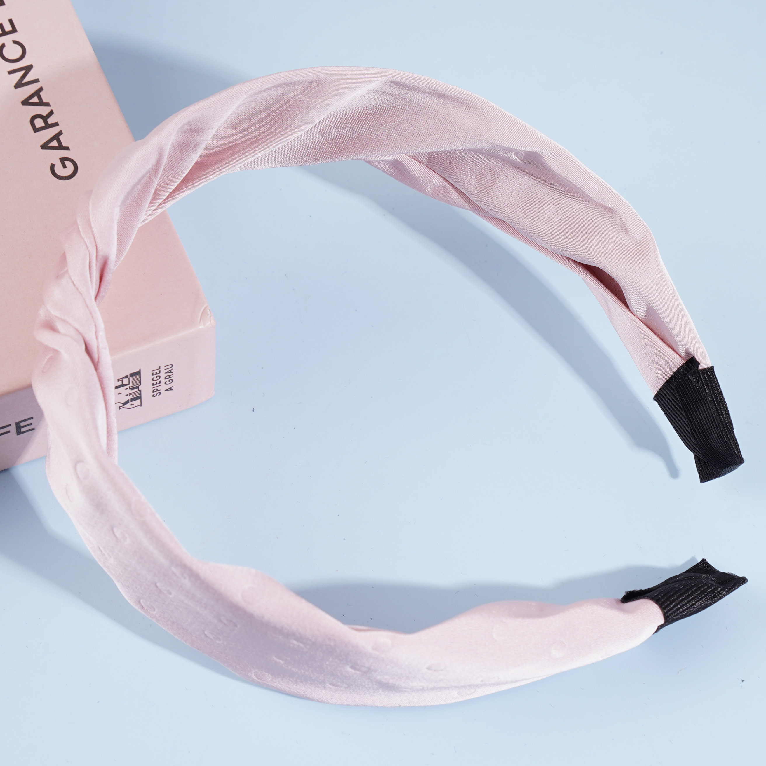 A knotted lace headband with dots and a bow decoration