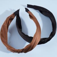 A knotted lace headband with dots and a bow decoration