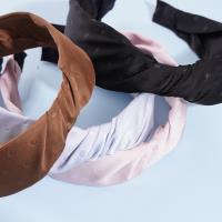 A knotted lace headband with dots and a bow decoration