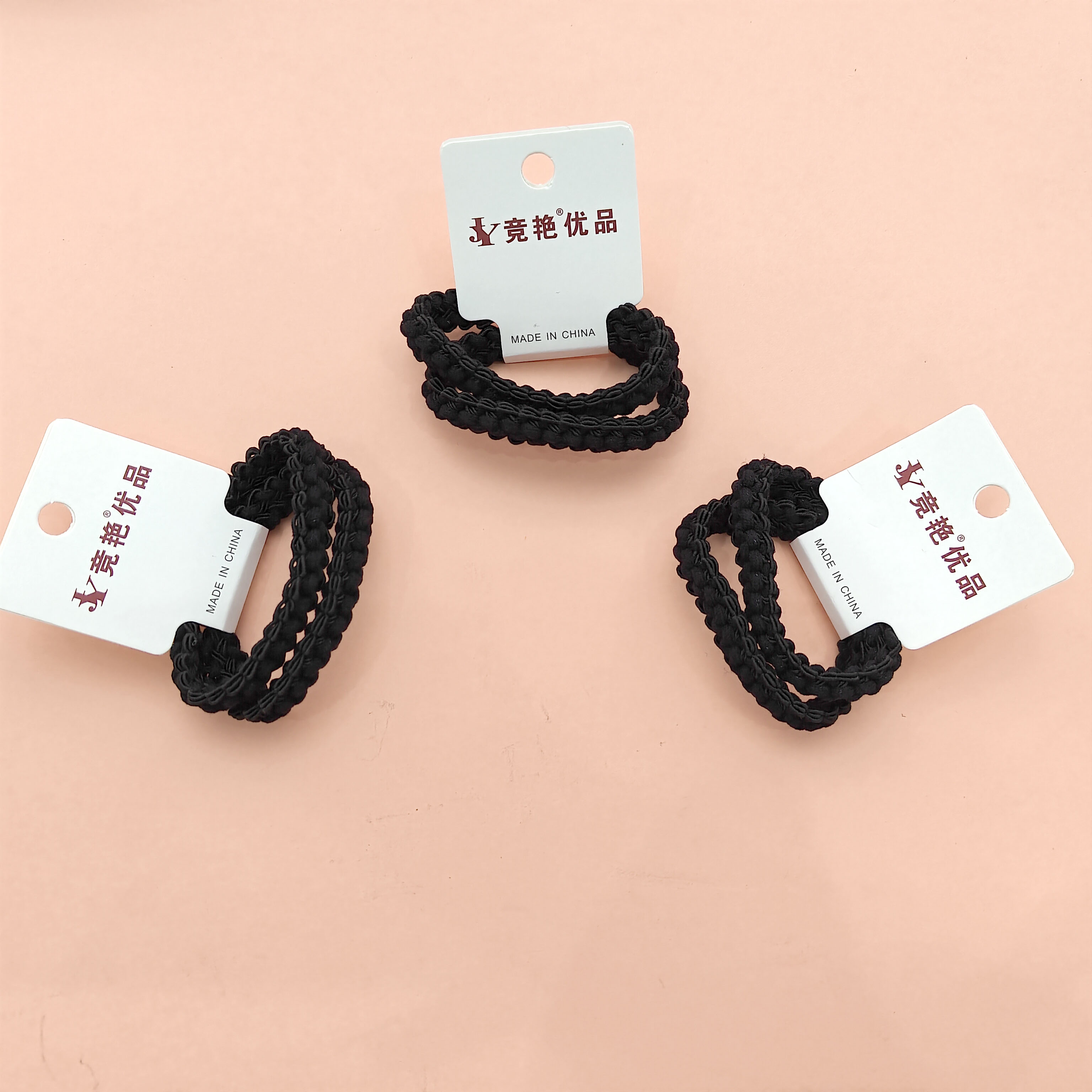 2 pieces of black cord with pressed edges