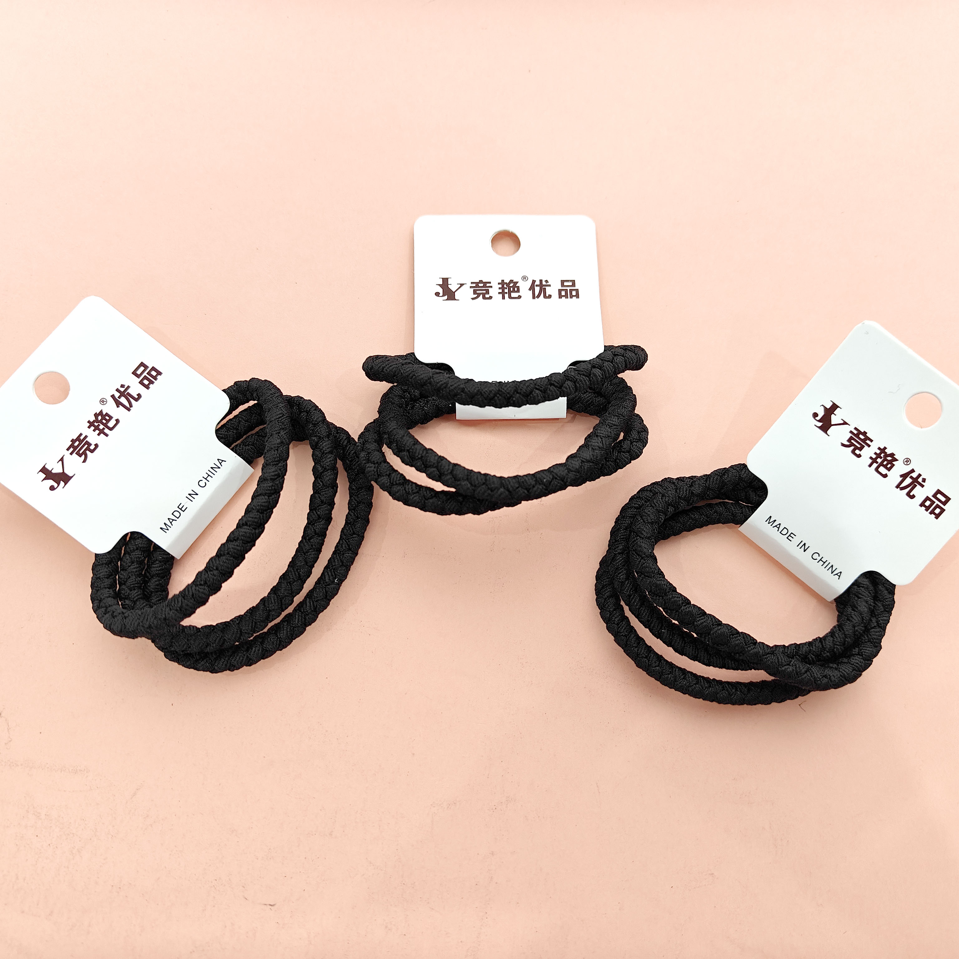 3 pieces of thick-headed ropes with black braided ponytails attached to them