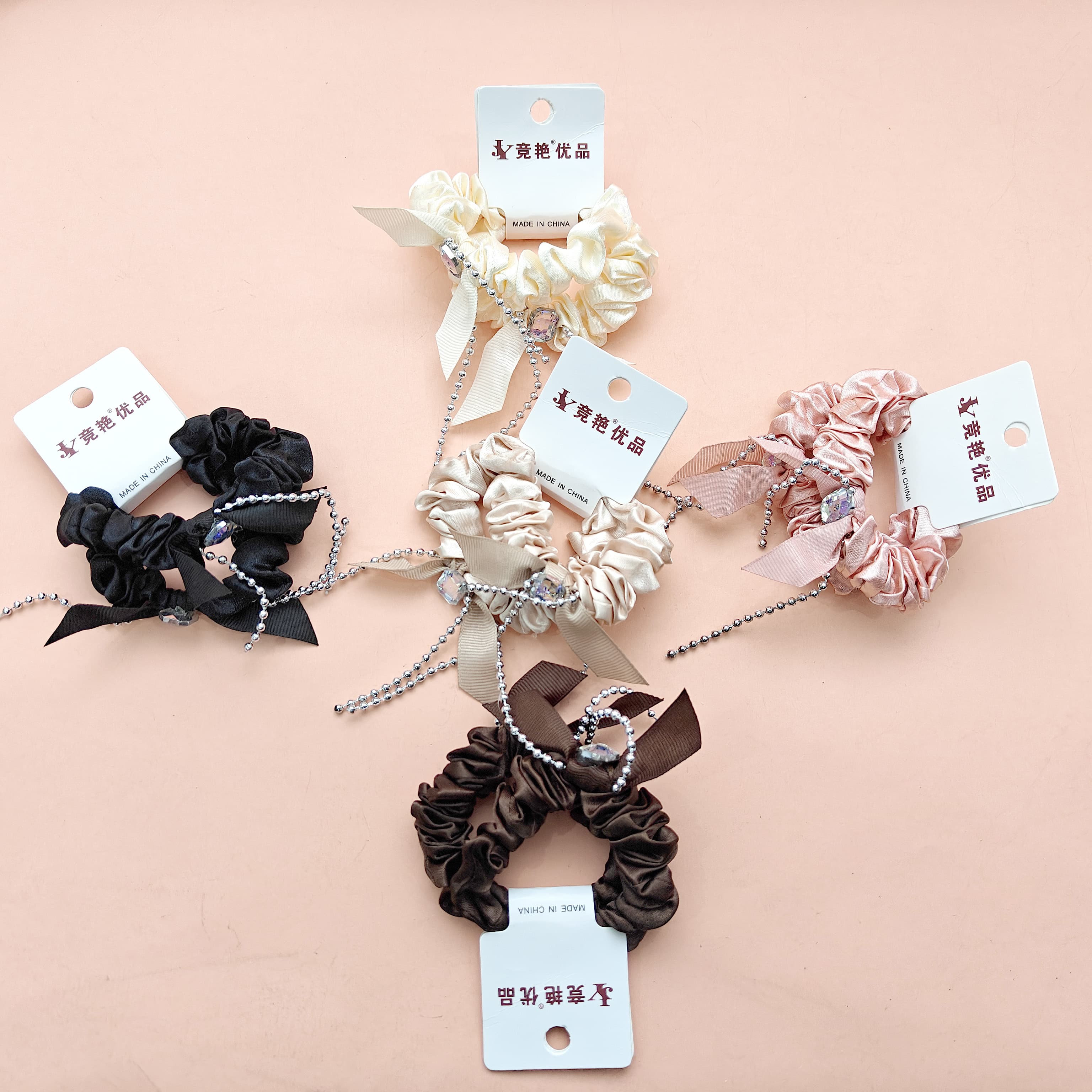 2 strings of square-cut diamond-shaped beaded necklaces with tassels at the ends