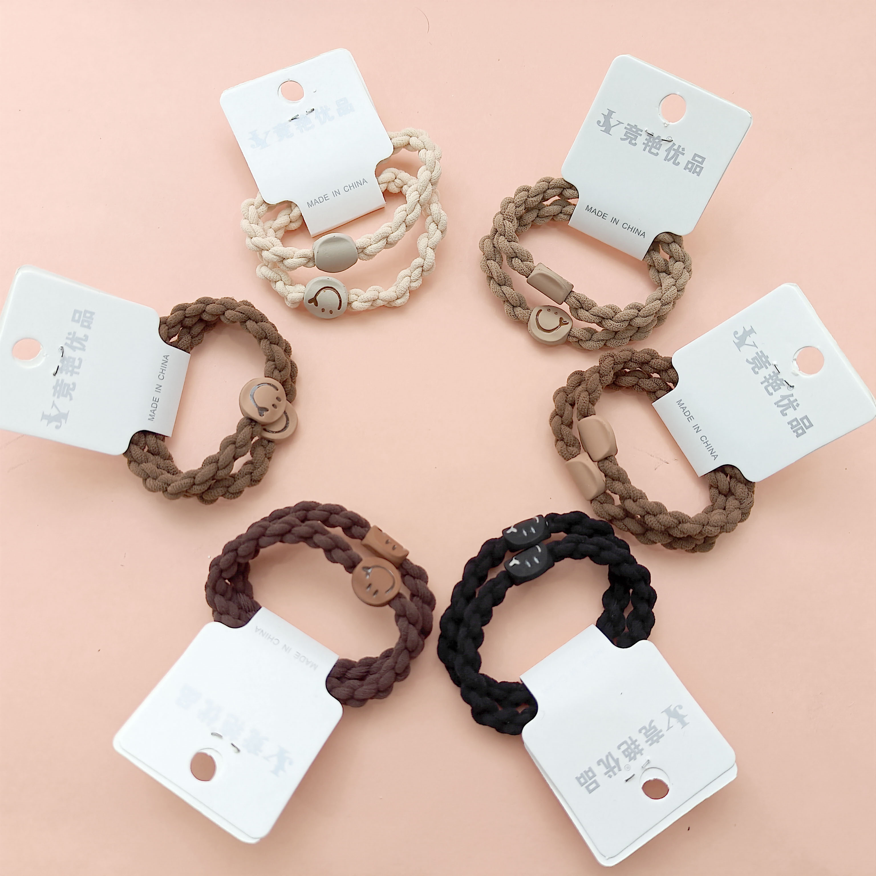 2 black-brown, versatile smile-themed woven hair ties