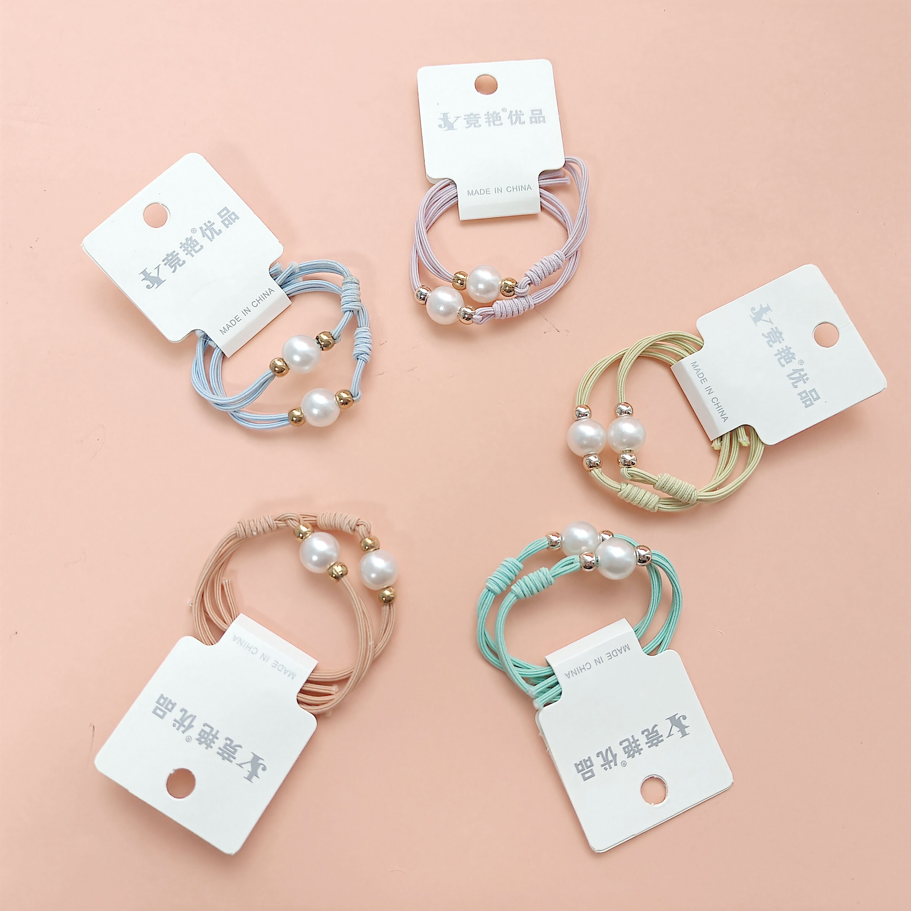 2 necklaces made of large candy-colored pearls with tassels at the ends