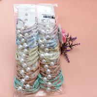 2 necklaces made of large candy-colored pearls with tassels at the ends