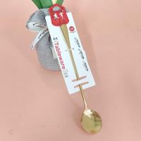 A gold-plated ice scoop with a thick handle